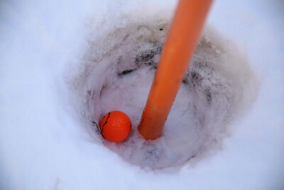 Talvigolfissa pelataan punaisella pallolla, joka erottuu lumesta.